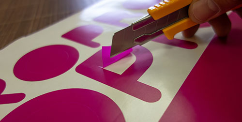 Image of a vinyl on the side of a wall in a office building.